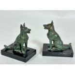 A pair of spelter patinated bronze seated German Shepherd bookends on black marble bases, (h 13cm