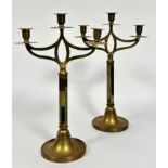 A pair of Art Nouveau style brass three branch candelabra on octagonal columns and circular