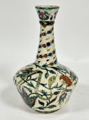 An Iznik bottle neck vase with flared rim, decorated with stylised serpent, bird and lotus flower