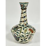 An Iznik bottle neck vase with flared rim, decorated with stylised serpent, bird and lotus flower