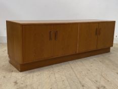 G-Plan, a mid century teak sideboard, fitted with two twin cupboard doors, raised on a pedestal,