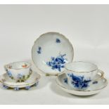 A pair of Meissen porcelain saucers decorated with blue and gilt floral sprays, with butterfly,