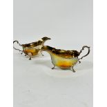 A pair of Birmingham 1938 silver George III style scalloped sauce boats with C scroll handle to
