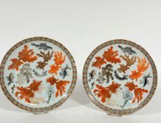 A pair of Japanese porcelain plates decorated with fish and crustacea including puffer fish,