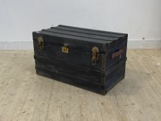 An early 20th century wooden bound steamer trunk, The hinged top opening to a silk lined interior,