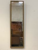 A 20th century gilt composition framed wall hanging mirror, 102cm x 29cm