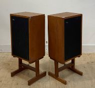 A pair of Goodmans teak cased speakers on stands, H82cm, W35cm, D26cm