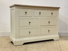 A Contemporary limed ash and white laminate chest, fitted with three short and four longer