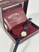 A Rotary 9ct gold lady's wrist watch with white enamelled dial and baton hour markers, on black