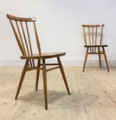 Ercol, A pair of Vintage beech and elm comb back dining chairs, each with shaped seats raised on