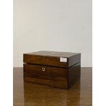 A Victorian rosewood vanity box, the lid inlaid with mother of pearl cartouch, opening to a red
