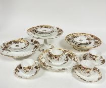 An Edwardian French Limoges part coffee set including four coffee cans, one repaired, one with