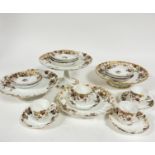 An Edwardian French Limoges part coffee set including four coffee cans, one repaired, one with