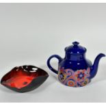 A mid century blue glazed and transfer printed stylised lotus leaf and flower designed teapot (