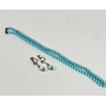 A blue glass child's bead necklace with barrel style fastening, (L: 18cm) and a pair of blue faceted