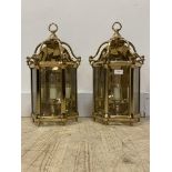 A pair of three branch lacquered gilt brass wall sconces formed as hall lanterns, inset with