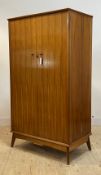Alfred Cox for AC furniture, a mid century teak wardrobe, with two doors enclosing a fitted