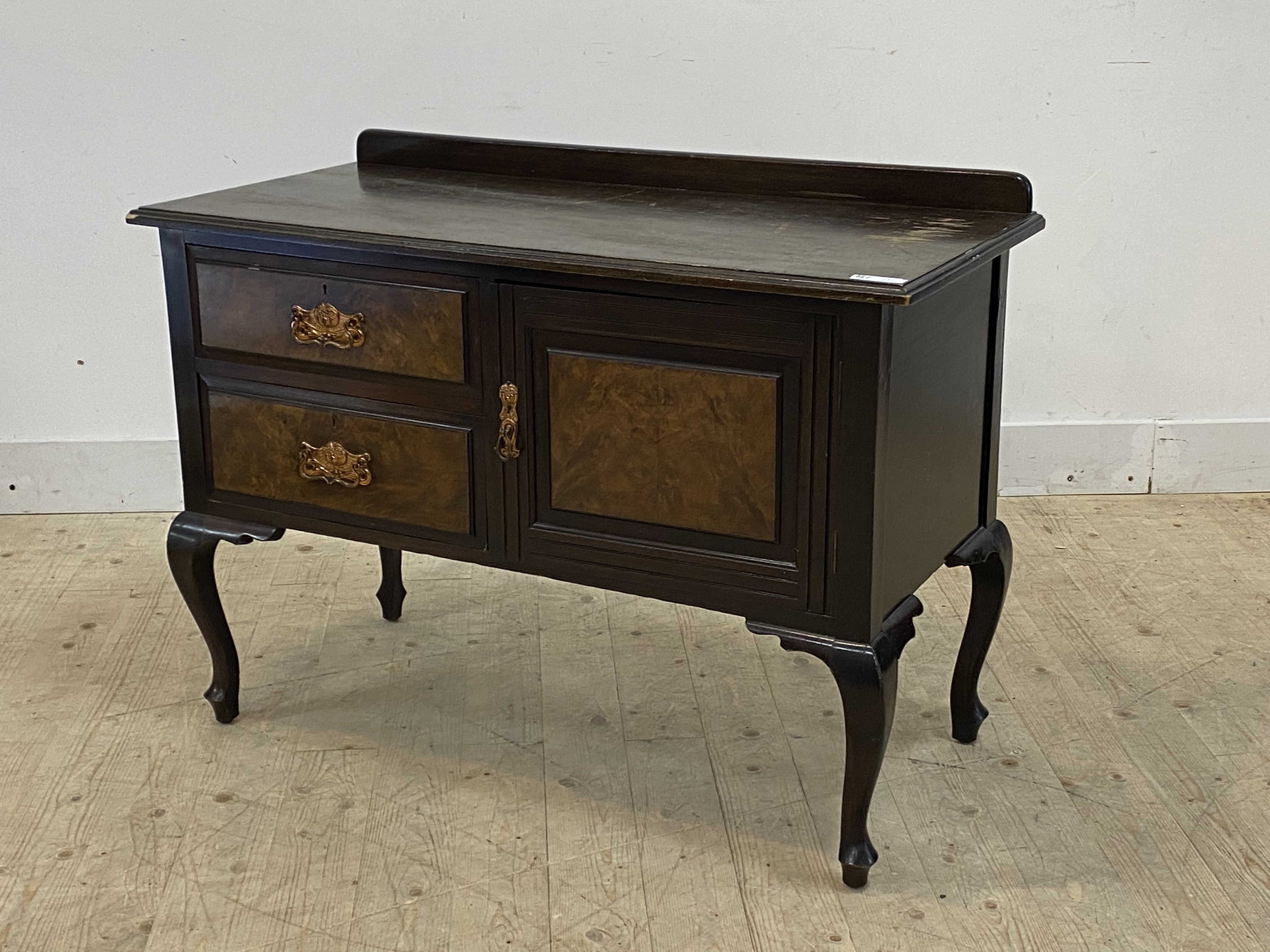 A late Victorian figured walnut wash stand, fitted with a drawer and cupboard, raised on cabriole