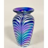 An Arts and Crafts art glass tapered cylinder vase with feathered white and blue iridescent panelled