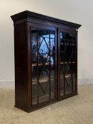 A Georgian inlaid mahogany bookcase cabinet, the dentil cornice over two astragal glazed doors