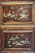 A pair of late 19thc early 20thc cherry wood panels with pierced borders, the centre panels