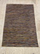 A contemporary wool pile rug of all over polychromatic lineal design, 202cm x 296cm