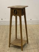 An Arts and Crafts period oak jardiniere stand, the square top raised on square tapered and