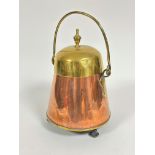 A Dutch style brass tapered cylinder coal bucket with loop handle to top and finial, copper base, (