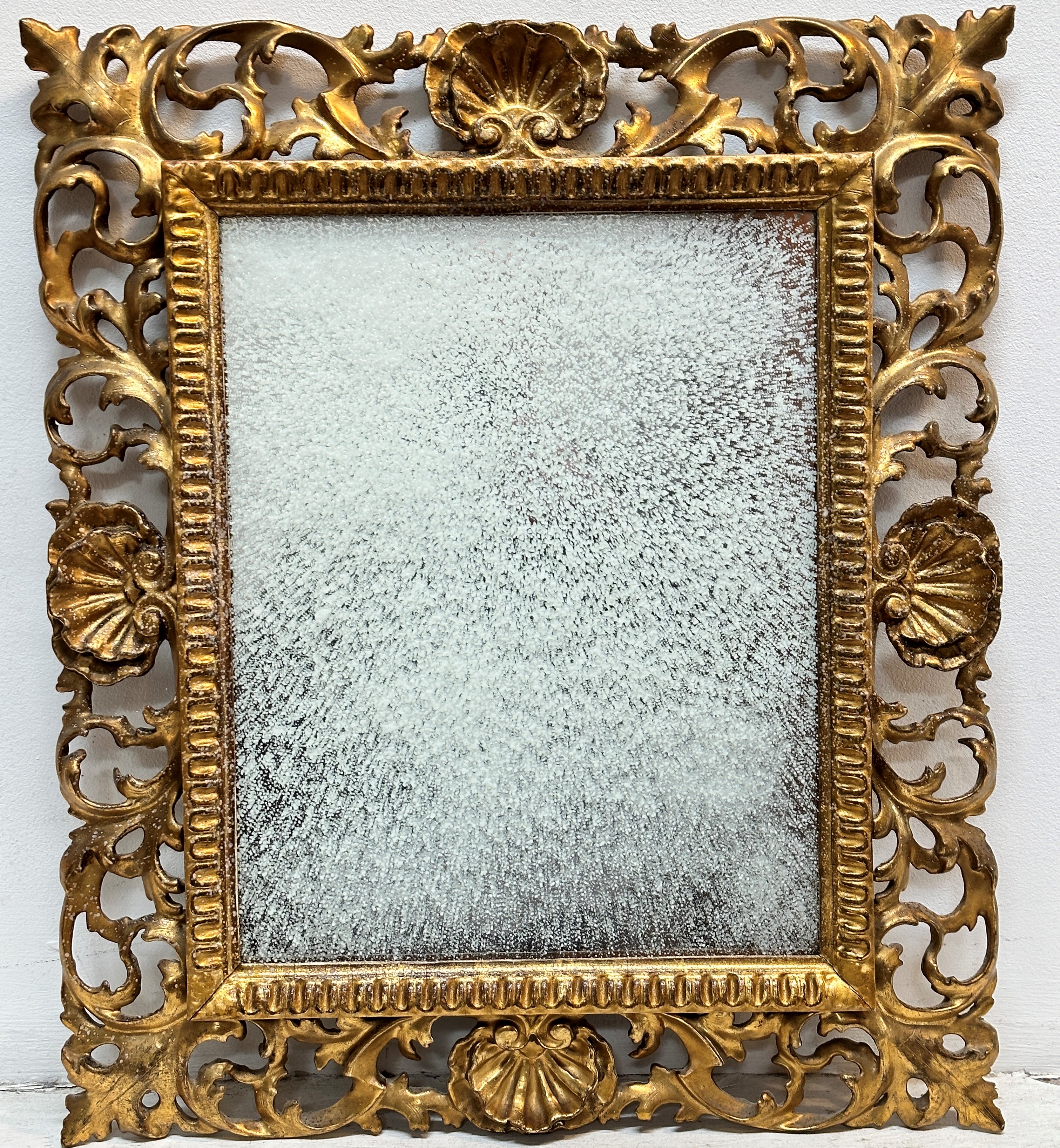 Florentine gilt framed wall mirror with shell and ivy leaf scrolling frame and fluted