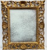 Florentine gilt framed wall mirror with shell and ivy leaf scrolling frame and fluted