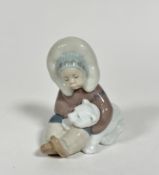 A Spanish Lladro porcelian figure of an Eskimo playing with a polar bar cub, (h 12.5cm x 10cm x 7cm)