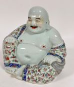 A late 19thc early 20thc Chinese Happy Buddha seated figure with one leg crossed with pierced ear