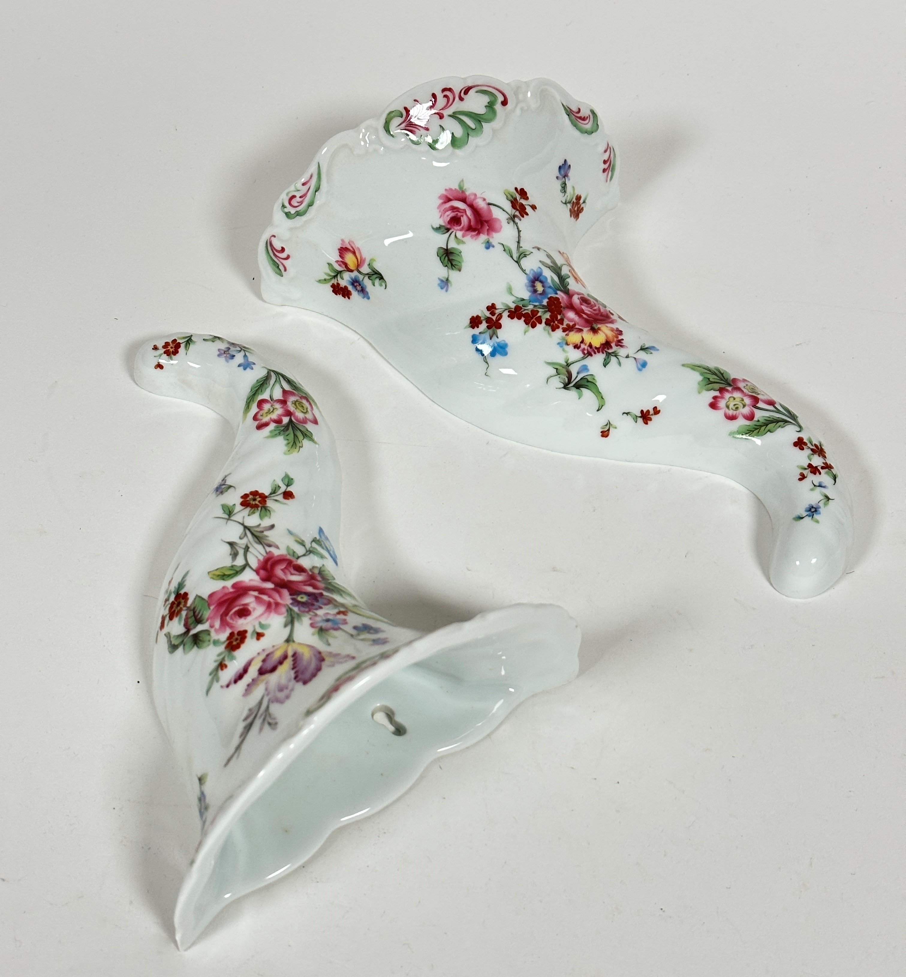 A pair of Royal Worcester porcelain cornucopia wall pockets with scalloped tops decorated with tulip