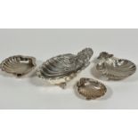 A group of four small Epns shell shaped butter dishes, the largest with fan shell handle to end,