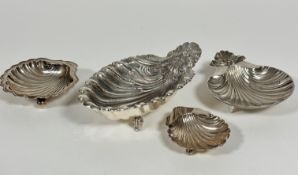 A group of four small Epns shell shaped butter dishes, the largest with fan shell handle to end,