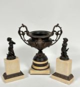 A resin model of a classical two handled urn with C scroll handles to side and mask panel front,