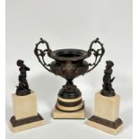 A resin model of a classical two handled urn with C scroll handles to side and mask panel front,