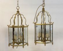 A pair of gilt brass six branch hall lanterns of hexagonal outline, inset with glass panels H66cm