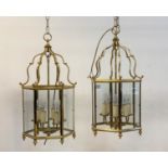 A pair of gilt brass six branch hall lanterns of hexagonal outline, inset with glass panels H66cm