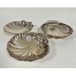 A group of three Epns large fan shell shaped serving dishes, (largest h 5cm x 13cm x 28cm, fan shell