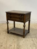 An early 20th century oak two drawer canteen table (lacking flatware) fitted with two drawers,