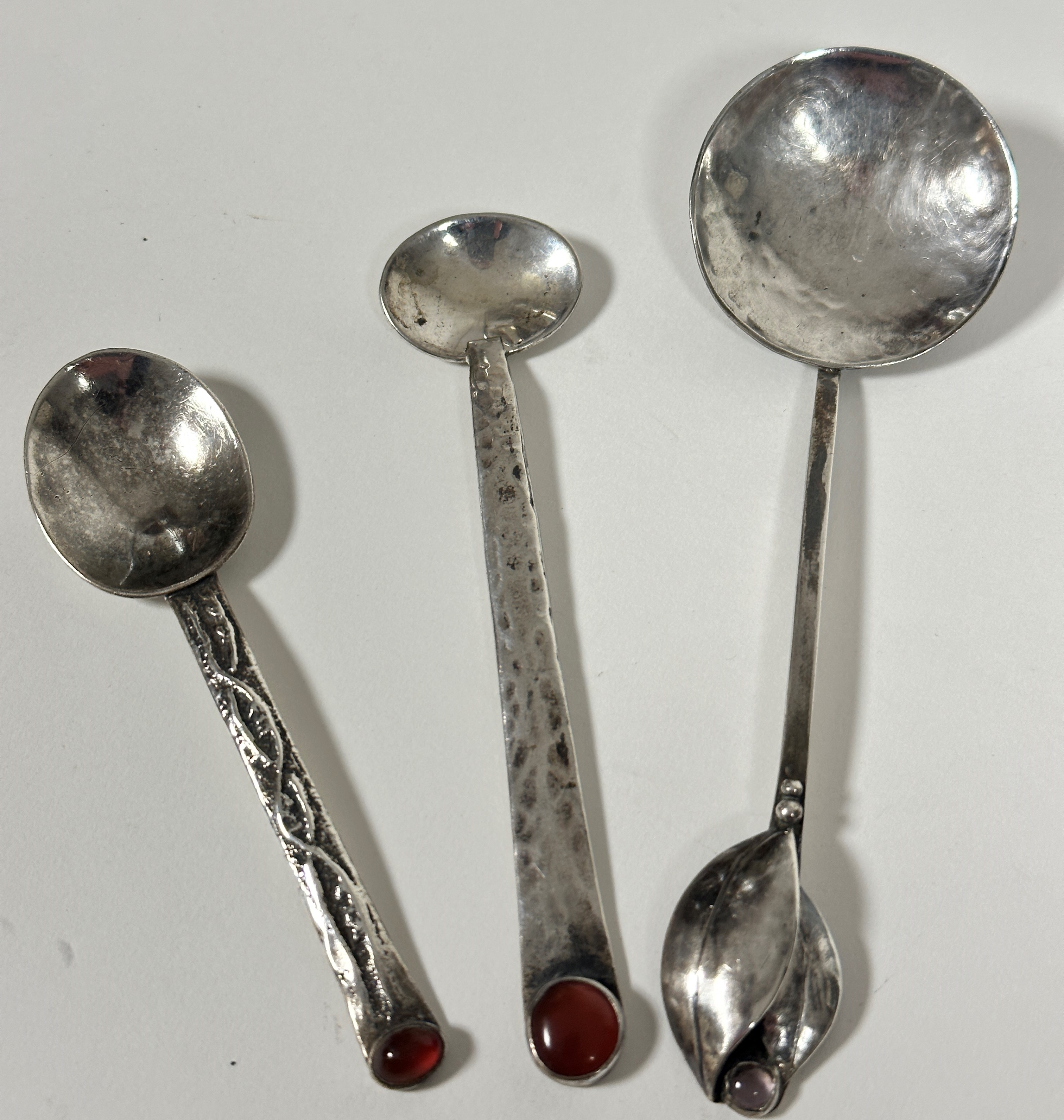 A Continental Georg Jensen style spoon, the square stem with twin leaf scrolling design inset with