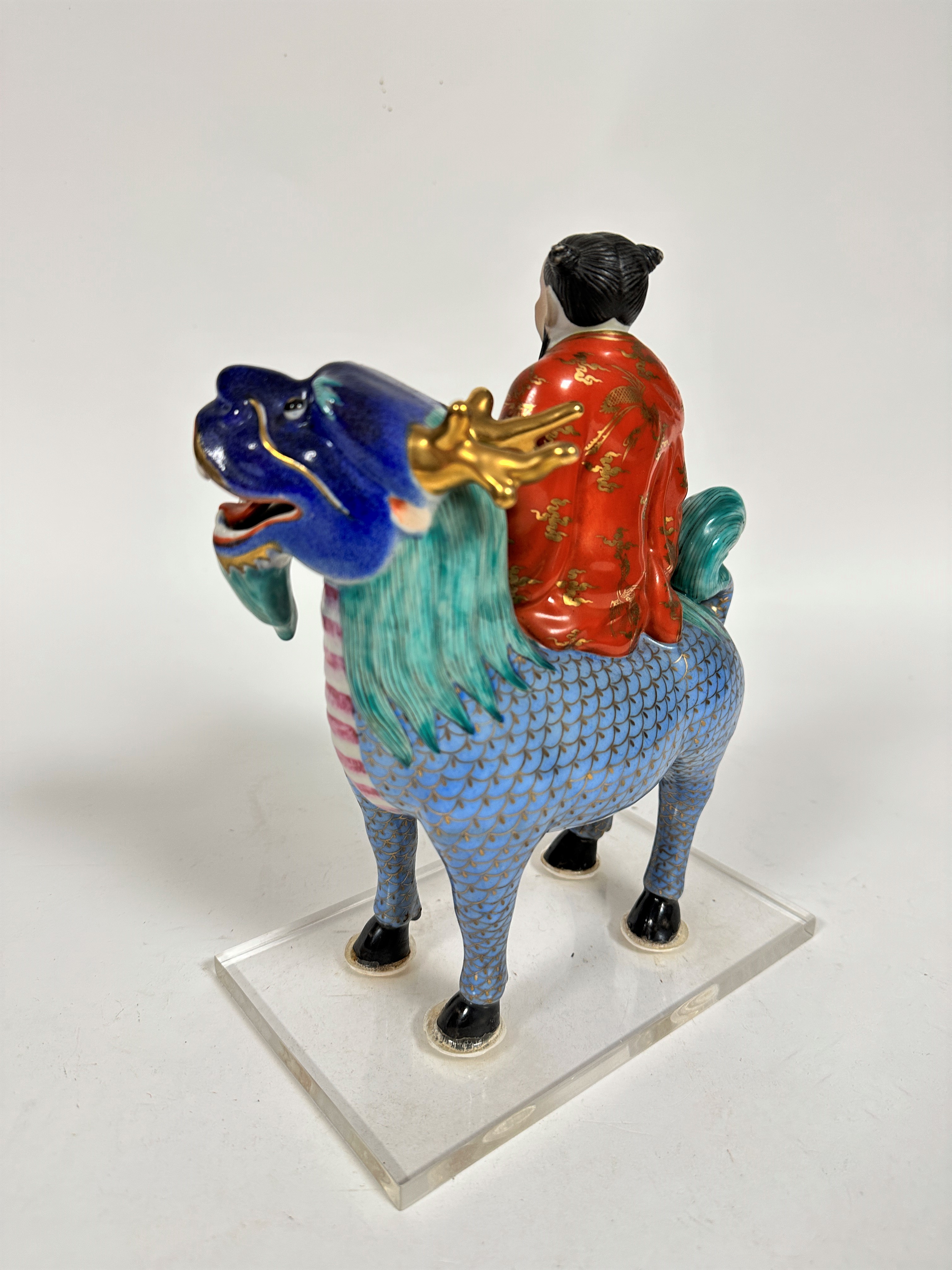 A Japanese porcelain Buddhist figure riding on a mythical stag, decorated with polychrome enamels, - Image 2 of 3