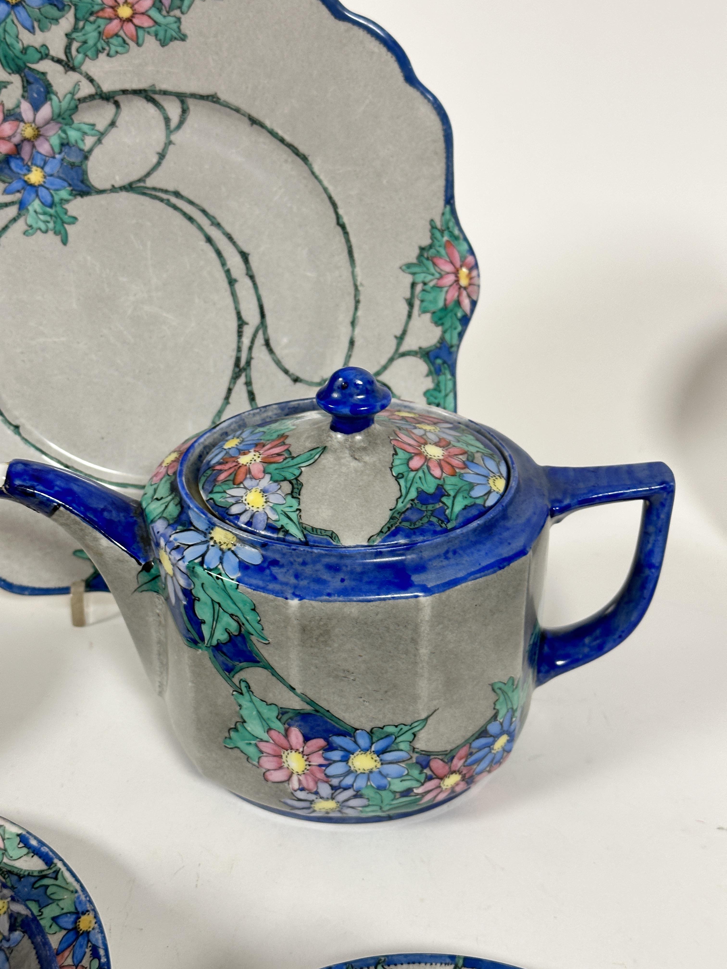 A fourteen piece 1920s tea set with handpainted floral scrolling leaf design with blue reserves - Image 3 of 4