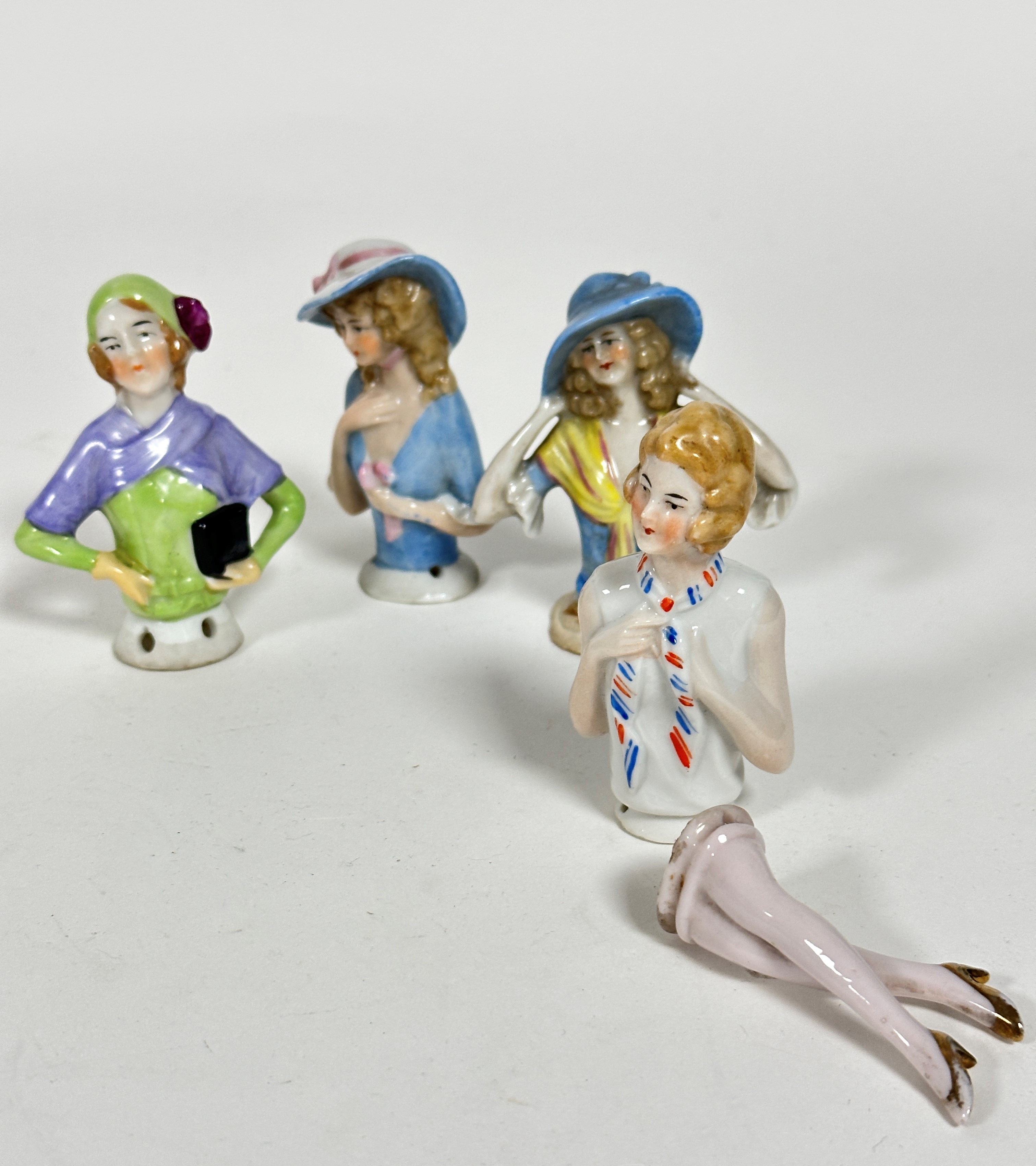 Two china pomander figures of ladies with hats, (h 7.5cm) a 1930s figure with cap and lavender shawl