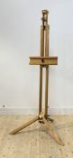 A large oak artists rise and fall folding easel, raised on a tripod base H171cm (Minimum)