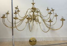 A large brass Dutch style chandelier with central column issuing eighteen scrolled branches D167cm