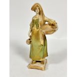 A Royal Vienna Wahliss porcelain figure of a maiden with a woven basket draped with vine leaves
