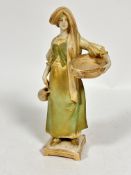 A Royal Vienna Wahliss porcelain figure of a maiden with a woven basket draped with vine leaves