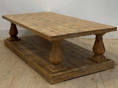 A large distressed pine two tier coffee table, the top raised on baluster turned supports, H45cm,